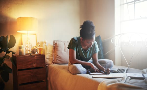 Student working on bed