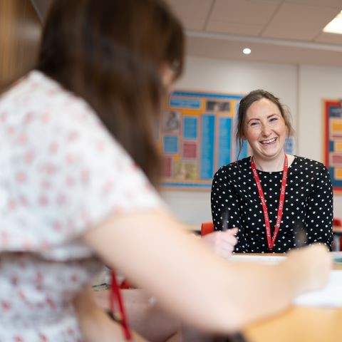 Student and adviser chatting in classroom