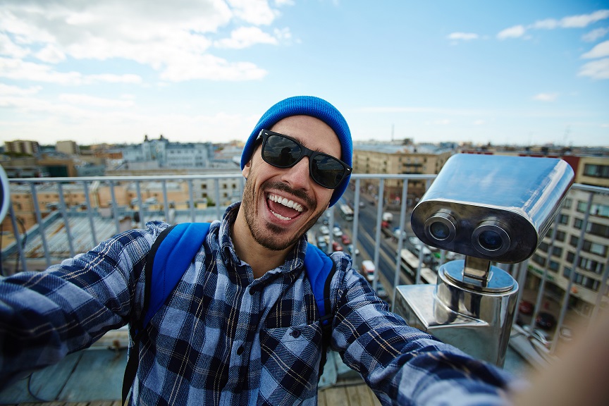 Student taking selfie on city viewing point 