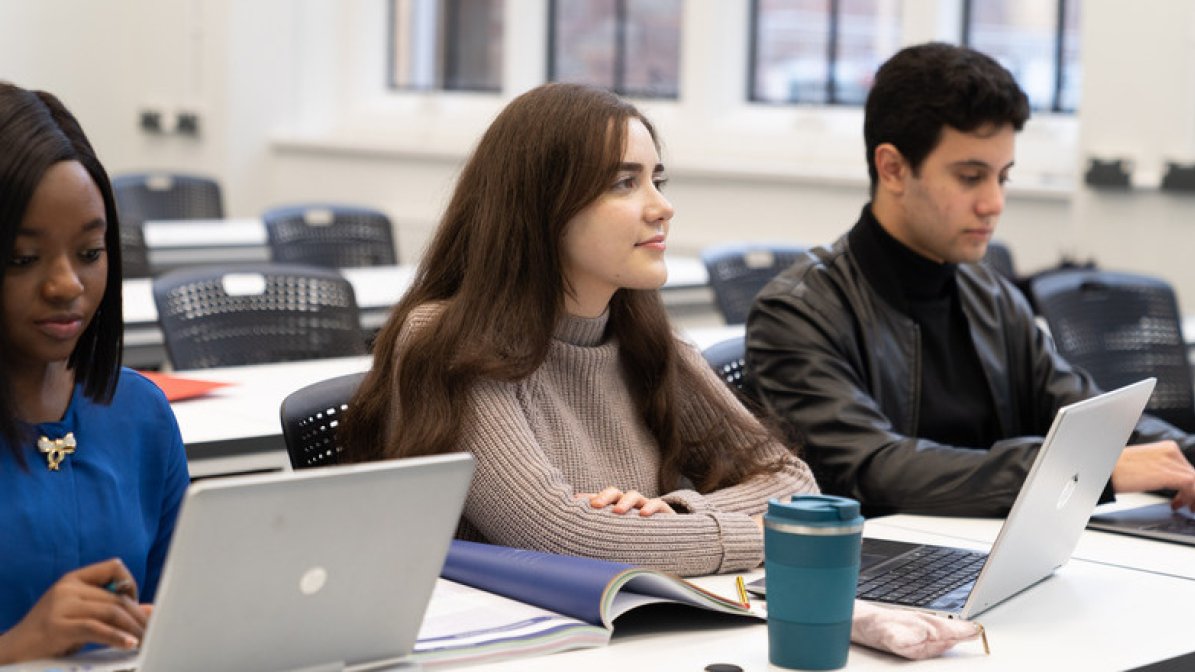 Students using laptops in classroom
