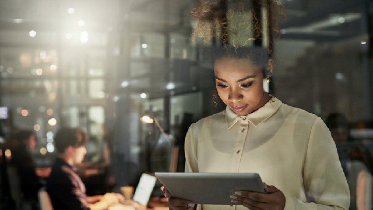 Digital community manager checking tablet in workplace
