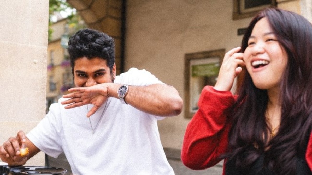 International students drinking coffee on uni campus 