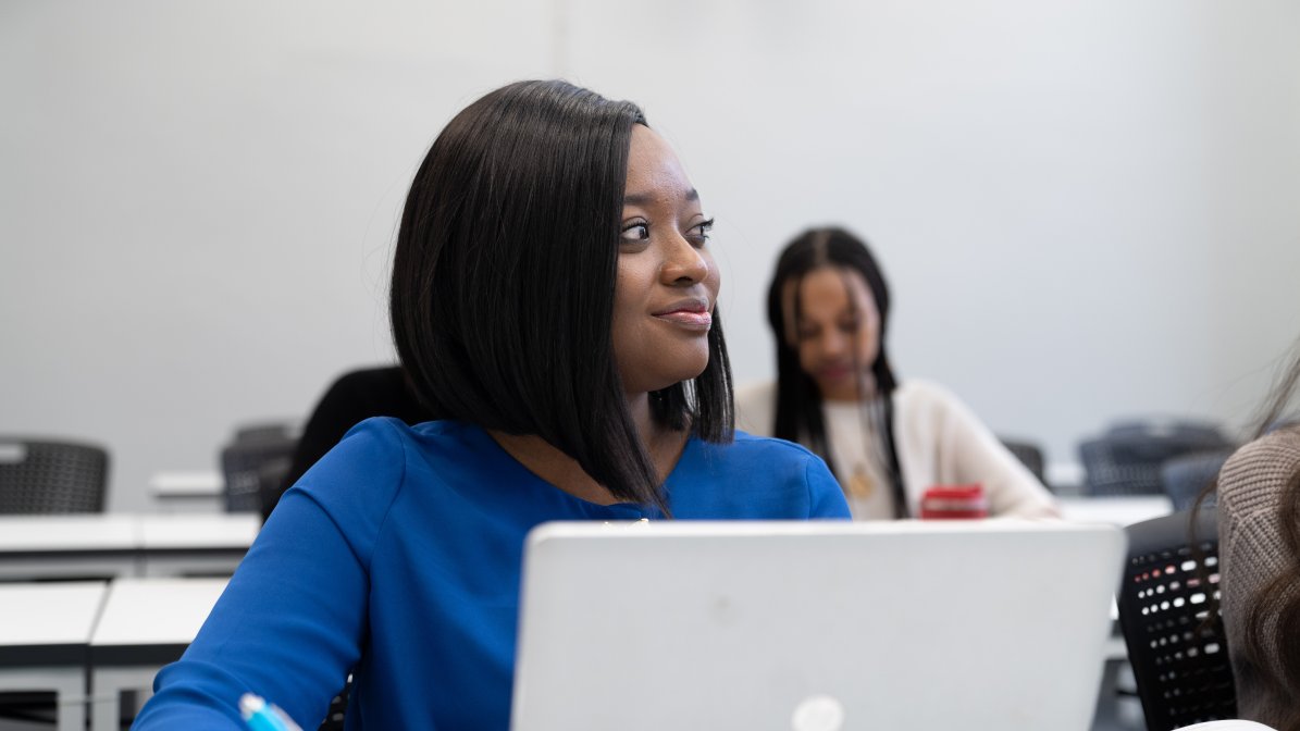 student on laptop in class