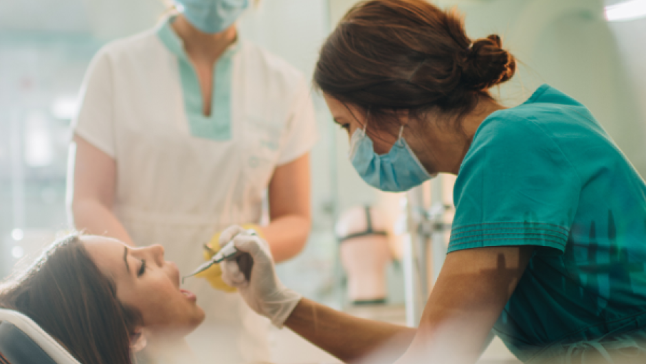 Dentist carrying out dental work on patient