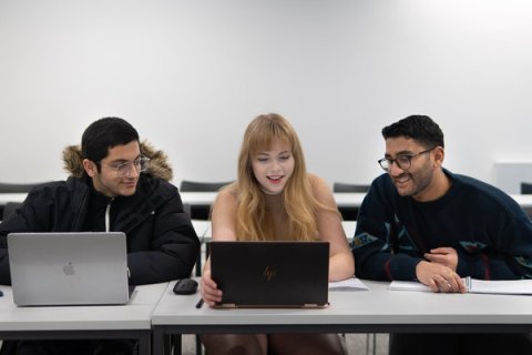 Students writing their personal statements on laptops